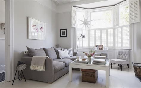 The rug includes both gray and blue to go with the rest of the room. Victorian terrace sitting room, plantation shutters, white wooden floors, grey sofa, light grey ...