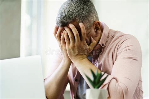 Sad Frustrated Middle Aged Man Covered His Face With Hands Sitting At