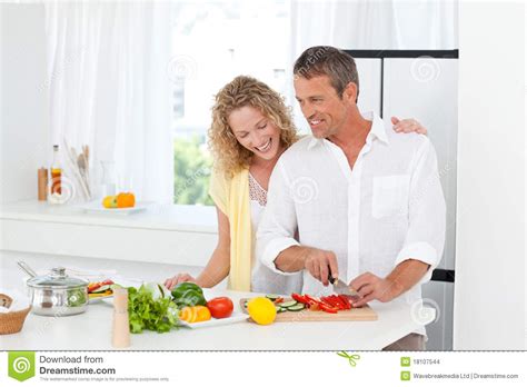 Couple Cooking Together In Their Kitchen Stock Images Image