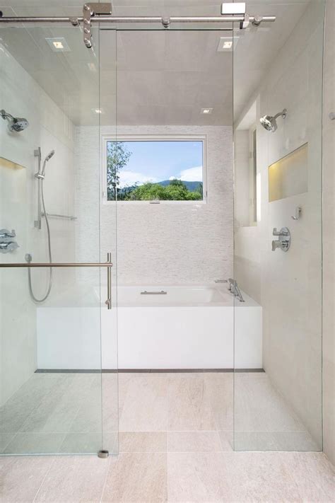 A Bathroom With A Glass Shower Door And Tub