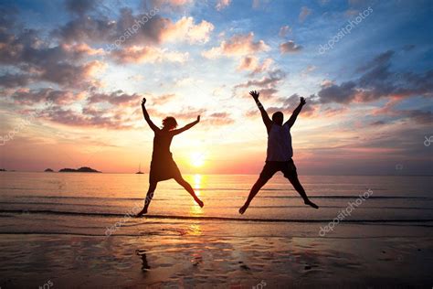 Concept Of Long Awaited Vacation Young Couple In A Jump On The Sea
