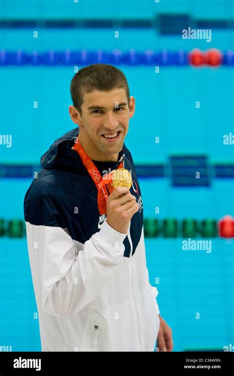 michael phelps usa shows off his gold medal for winning the 200m butterfly in world record
