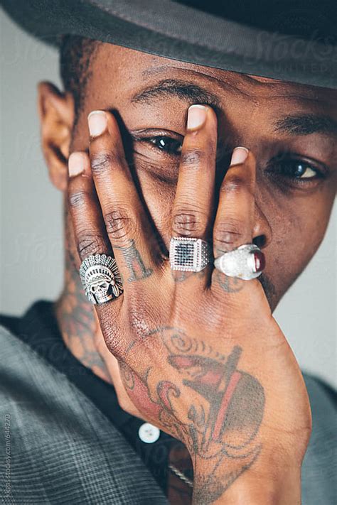 Close Up Of A Stylish Black Man Wearing Rings On A Tattooed Hand By