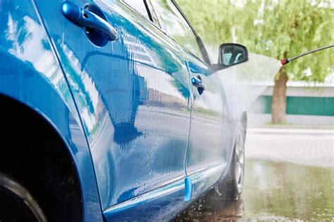 Cleaning Car With High Pressure Water At Car Wash Station Stock Photo
