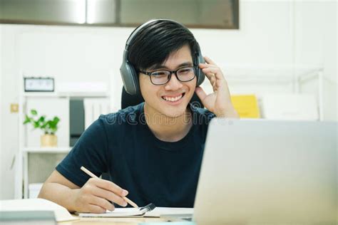 Young Man Study In Front Of The Laptop Computer At Home Stock Photo