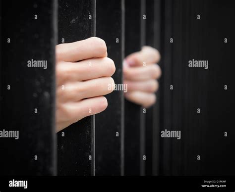 Prisoner Behind Jail Bars Stock Photo Alamy