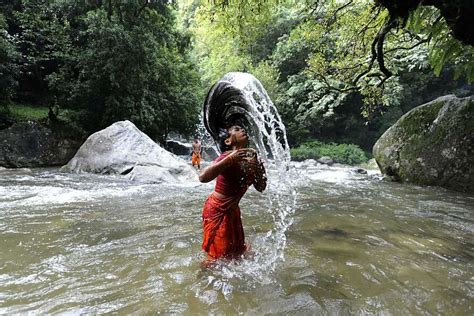 A Hindu Devotee Takes A Bath In The Bagmati River For Shravan Photo