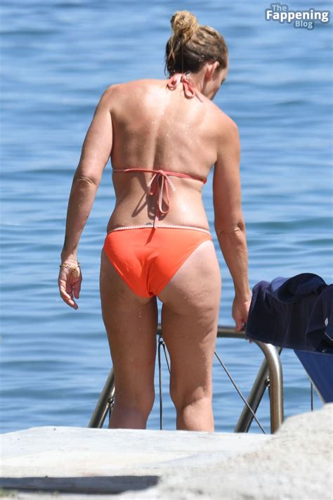toni collette wears an orange bikini as she s spotted sunbathing by the sea in ischia