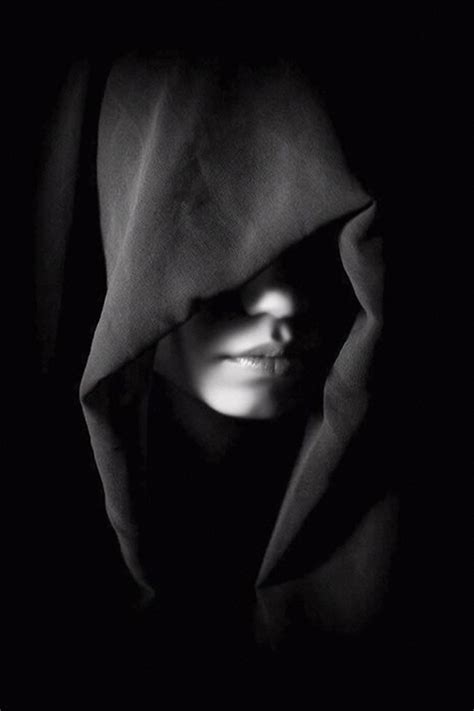 Mysterious Hooded Female Face In Shadows