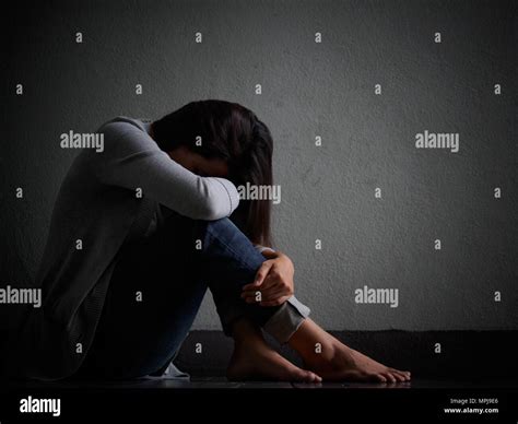 Sad Woman Hug Her Knee And Cry Sad Woman Sitting Alone In A Empty Room Stock Photo Alamy