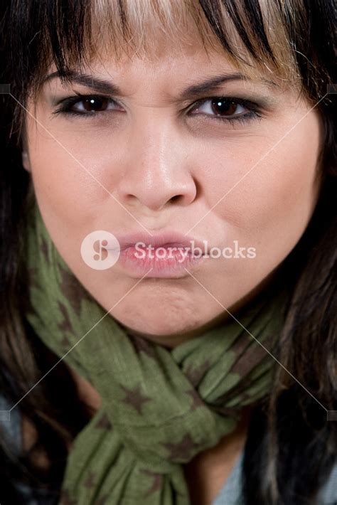 A Young Woman Making A Funny Face With Her Lips Puckered Royalty Free