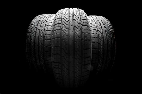 Premium Photo Stack Of Car Tires On Black Background