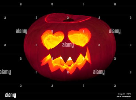 Face With Heart Shaped Eyes Carved Into A Pumpkin To Make Halloween