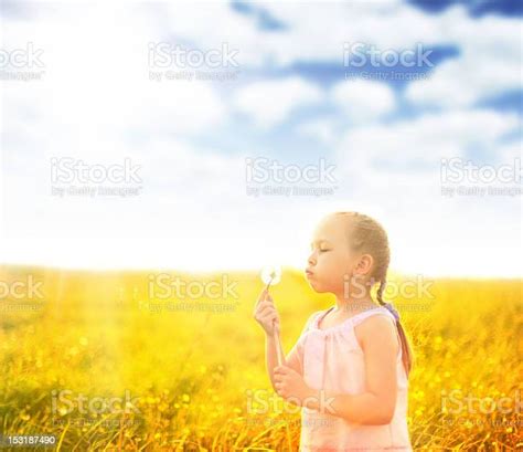 Little Girl Blowing Dandelions Stock Photo Download Image Now