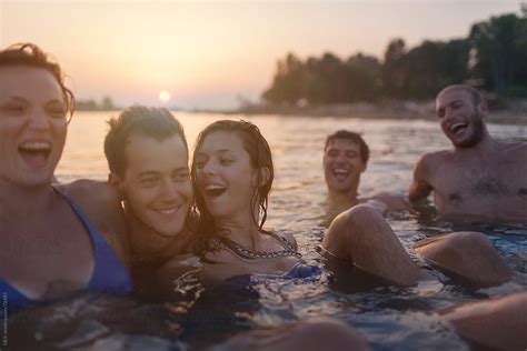 Friends Swimming During Sunset By Stocksy Contributor Mattia Stocksy