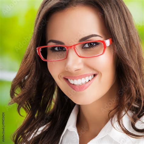 Portrait Of Young Smiling Brunette Businesswoman In Glasses