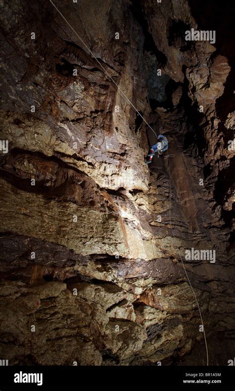 Cave Explorer Descends A Tensioned Line Into A Chamber Underground In A