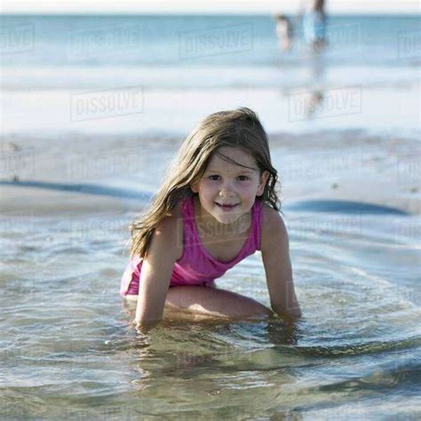 Girl Playing In Water On Beach Stock Photo Dissolve