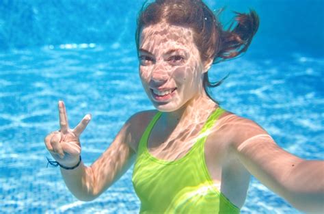 Premium Photo Child Swims Underwater In Swimming Pool Happy Active