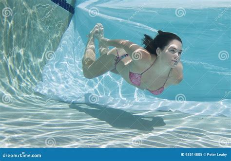 Woman Wearing A Bikini Swimsuit Holding Her Breathe Underwater Stock