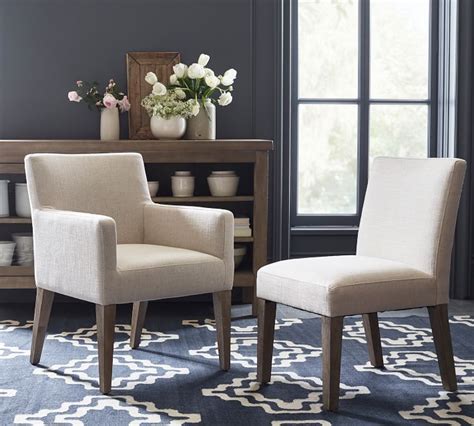 With their clear finish, these chairs can blend into a room or be the focal point. PB Classic Upholstered Dining Chair & Armchair | Pottery Barn