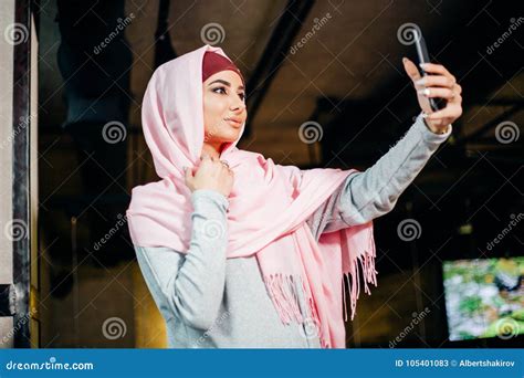 Portrait Of A Young Attractive Woman In Hijab Making Selfie Photo On Smartphone Stock Image