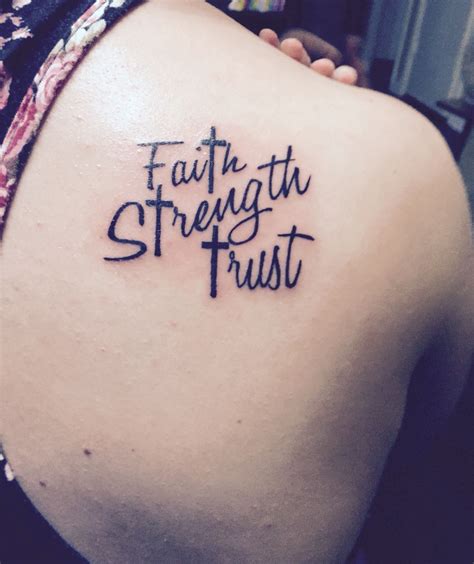 A Woman With A Tattoo On Her Back Saying Faith Strength Trust