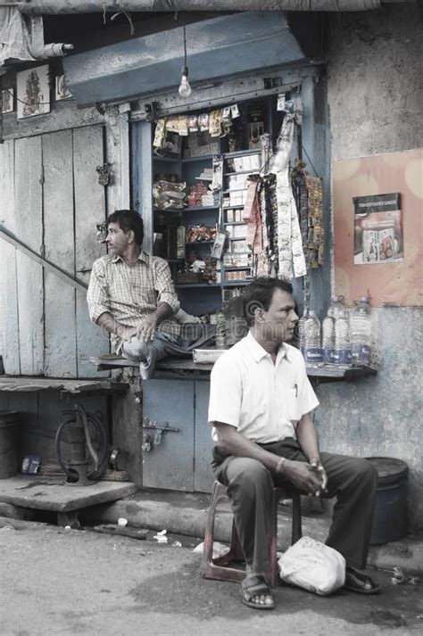 The Seller Of A Window Sized Convenience Store Waits For Customers In A Street Of Kolkata India