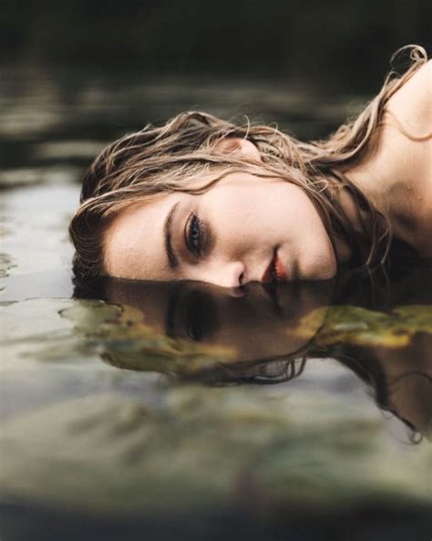A Woman Laying In The Water With Her Eyes Closed