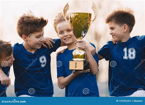 Boys Sports Team Celebrating Victory Happy Children Holding Golden