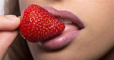 premium photo female lips eating red strawberry