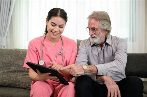 Young Doctor Or Nurse Visiting Happy Senior Patient At Home Stock Image Image Of Health