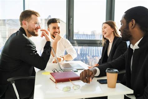 Group Of Business Partners Having Fun Talking At A Meeting In The