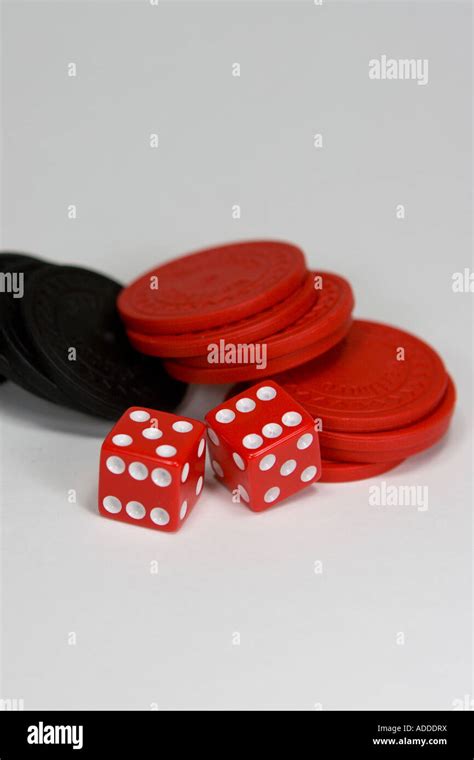 Two Red And White Dice Side By Side With Monetary Chips Stock Photo Alamy
