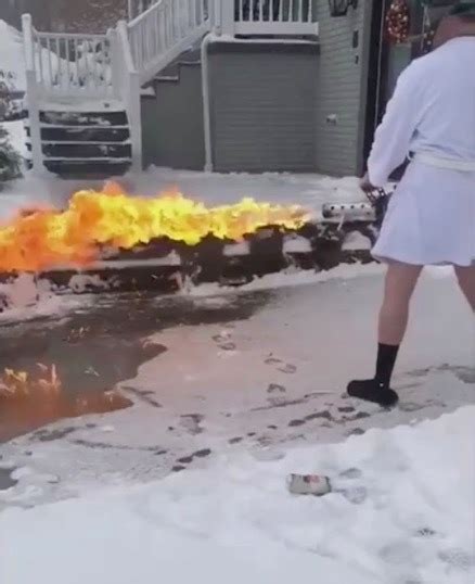 Man In Bathrobe And Slippers Uses Flamethrower To Clear Snow From His