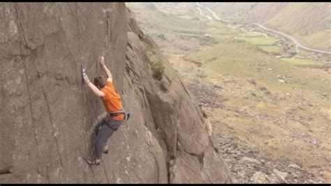 A Rock Climber Climbs Up A Steep Mountain Stock Footage Video 7025443