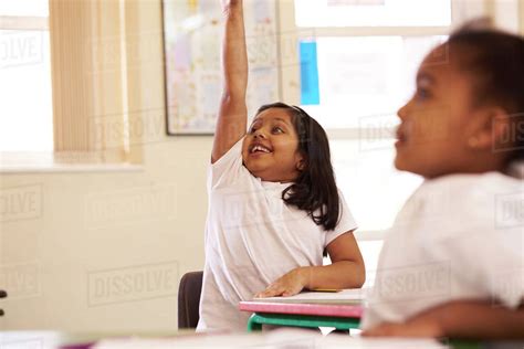 Enthusiastic Elementary School Pupil Answering Question Stock Photo