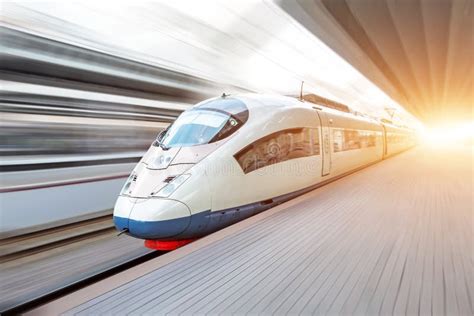 Modern High Speed Train Moves Fast Along The Platform Stock Photo