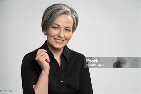 Charming Gray Haired Woman Wearing Black Shirt Smiles At Camera