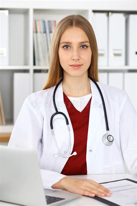 Brunette Female Doctor Using Laptop Computer In Hospital Healthcare