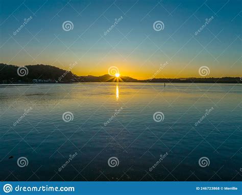 Clear Skies Sunburst Sunrise Waterscape Stock Photo Image Of Coastal