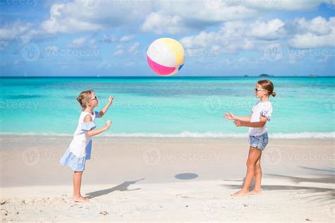 Little Adorable Girls Playing With Ball On The Beach Kids Having Fun