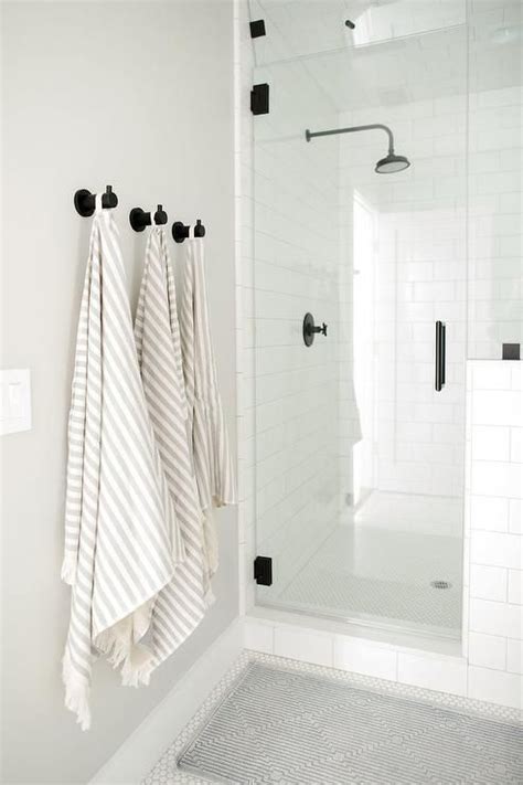 Beautiful towel bars and towel hangers for your bathroom. Oil rubbed bronze towel hooks are mounted to a light gray ...