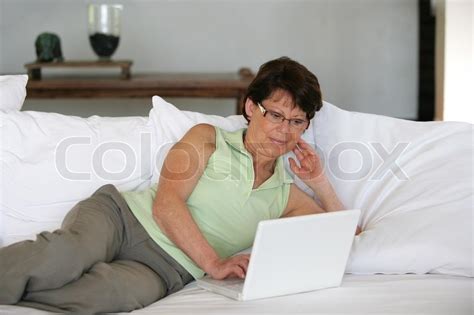 Mature Woman Using Her Laptop On A Sofa Stock Image Colourbox