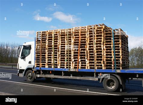 A Flatbed Truck Carrying A Load Of Pallets Along The A46 Dual