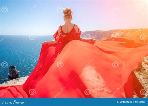 Woman Sea Red Dress Blonde With Long Hair On A Sunny Seashore In A Red