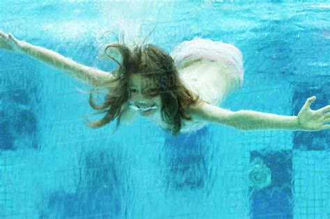 Girl Swimming Underwater In Swimming Pool Stock Photo Dissolve