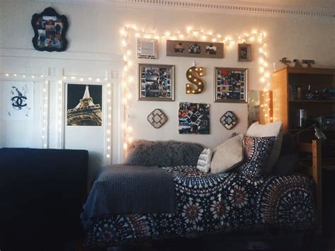 A Bedroom Decorated With Lights And Pictures On The Wall Above The Bed