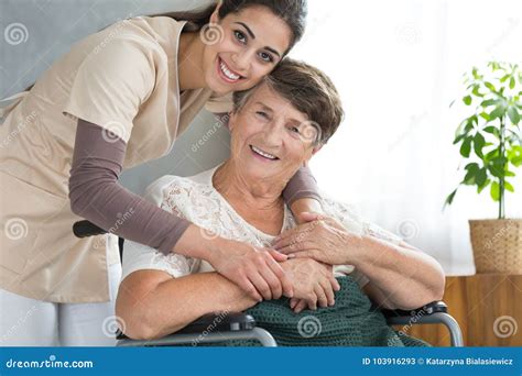 Pretty Caregiver Hugging Disabled Senior Stock Image Image Of Smile Room 103916293