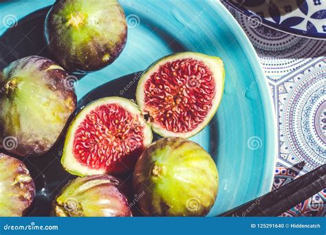 Whole And Half Cut Ripe Figs On Blue Plate Fruit Background Stock